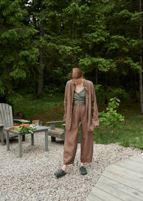 A girl in brown heavy linen trousers