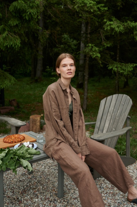 A linen button down shirt with drop-shoulders and a long hemline
