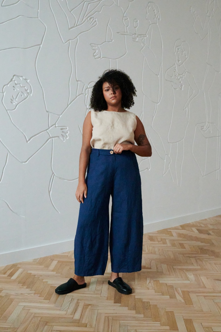 Model wearing navy blue linen trousers