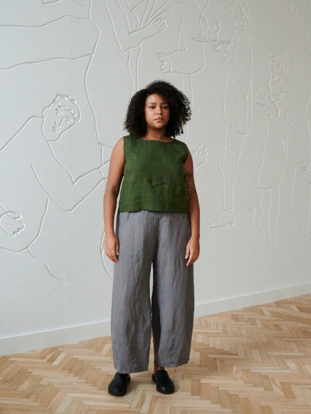 Model wearing a green cropped linen top and grey wide leg linen trousers outfit