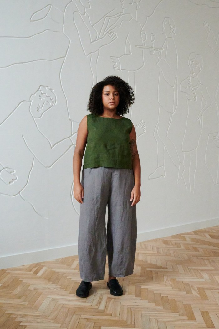 Model wearing a green cropped linen top and grey wide leg linen trousers outfit