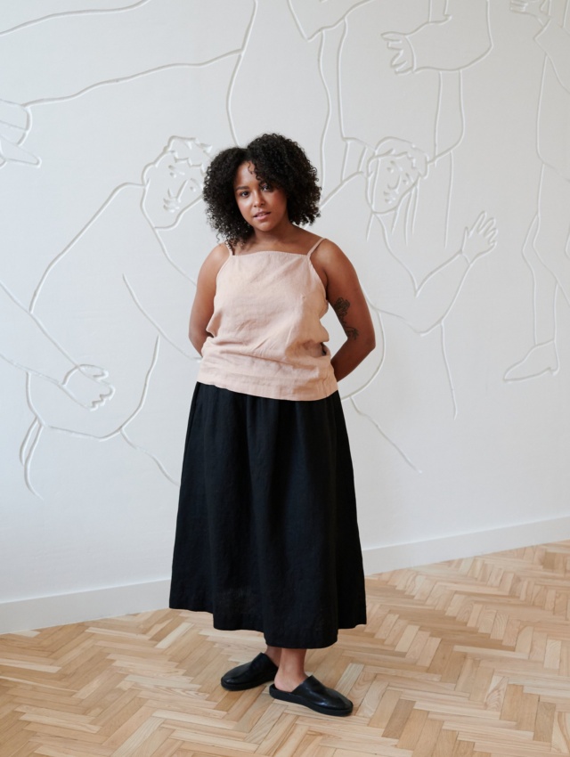 Model wearing a linen summer top paired with a flared linen maxi skirt