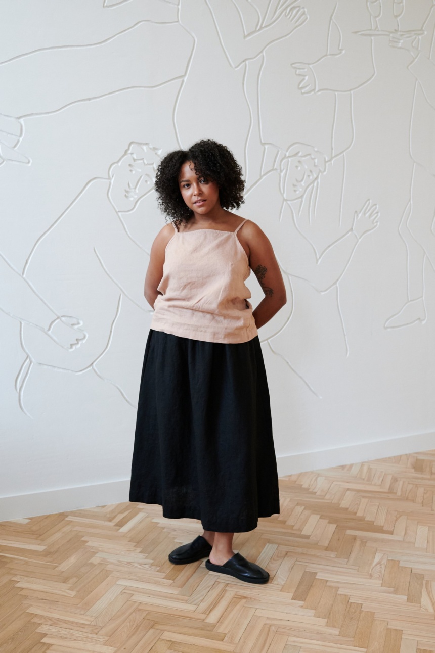 Model wearing a linen summer top paired with a flared linen maxi skirt