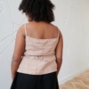 Back of a model wearing a linen summer top with spaghetti straps