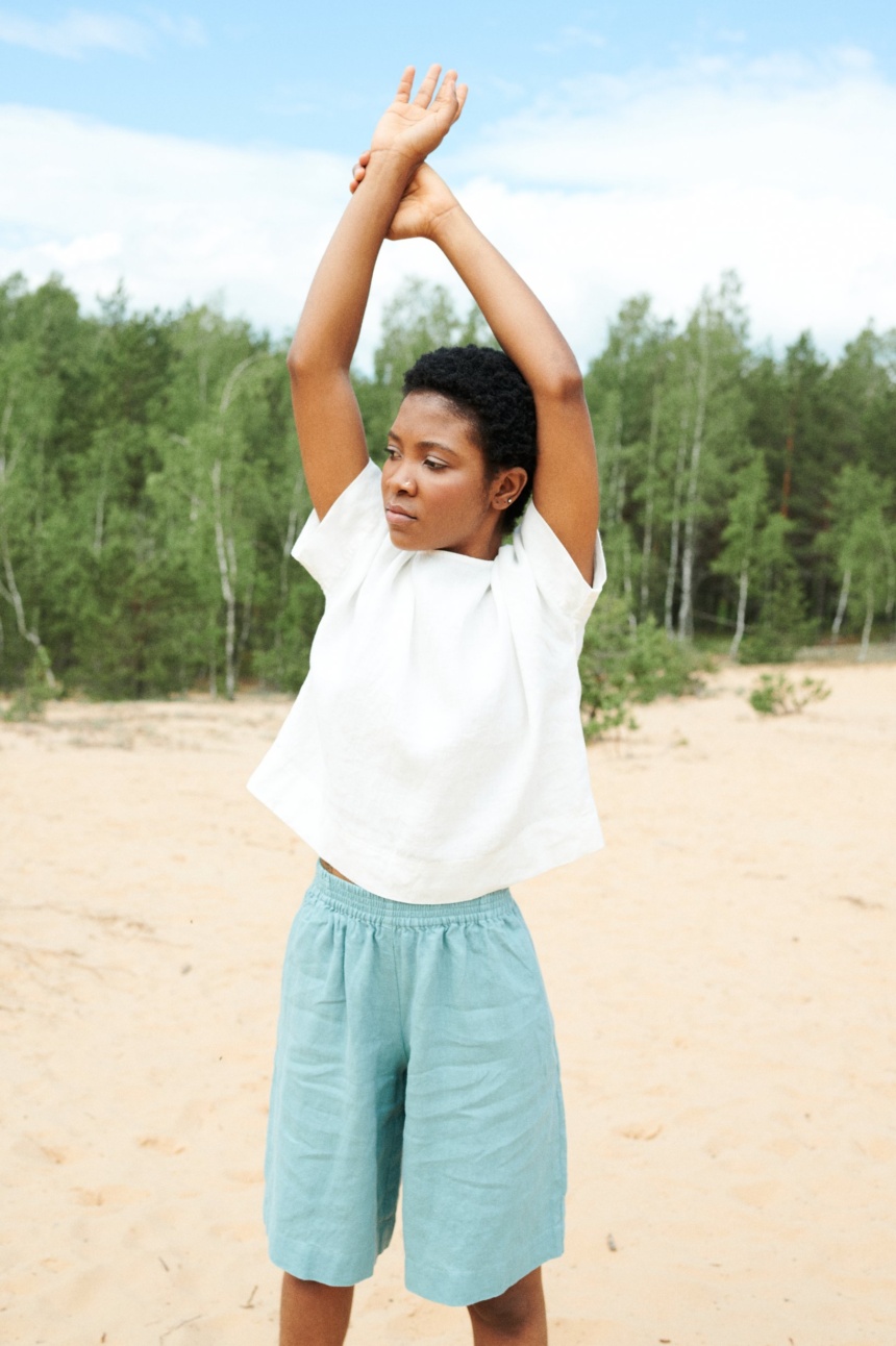 model wearing white linen top