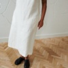 A slightly flared long white linen dress