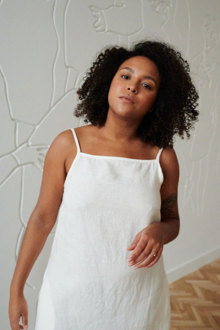 Top of a sleeveless white linen dress with thin straps