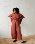 A model in brown linen wide leg trousers