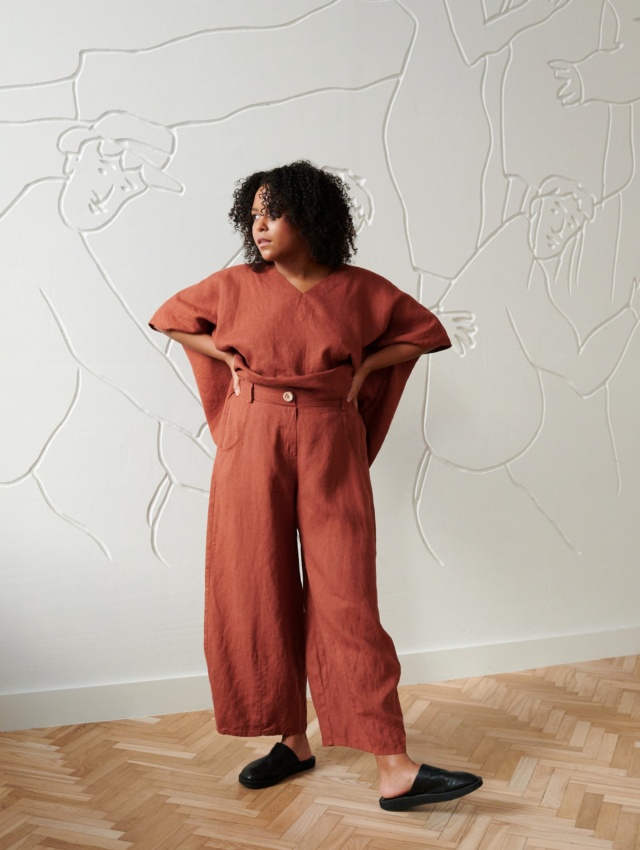 A model in brown linen wide leg trousers