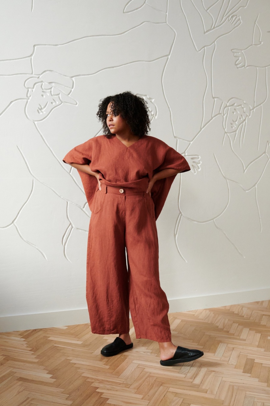 A model in brown linen wide leg trousers