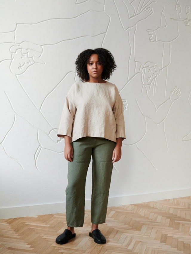 Model wearing dusty green utility trousers