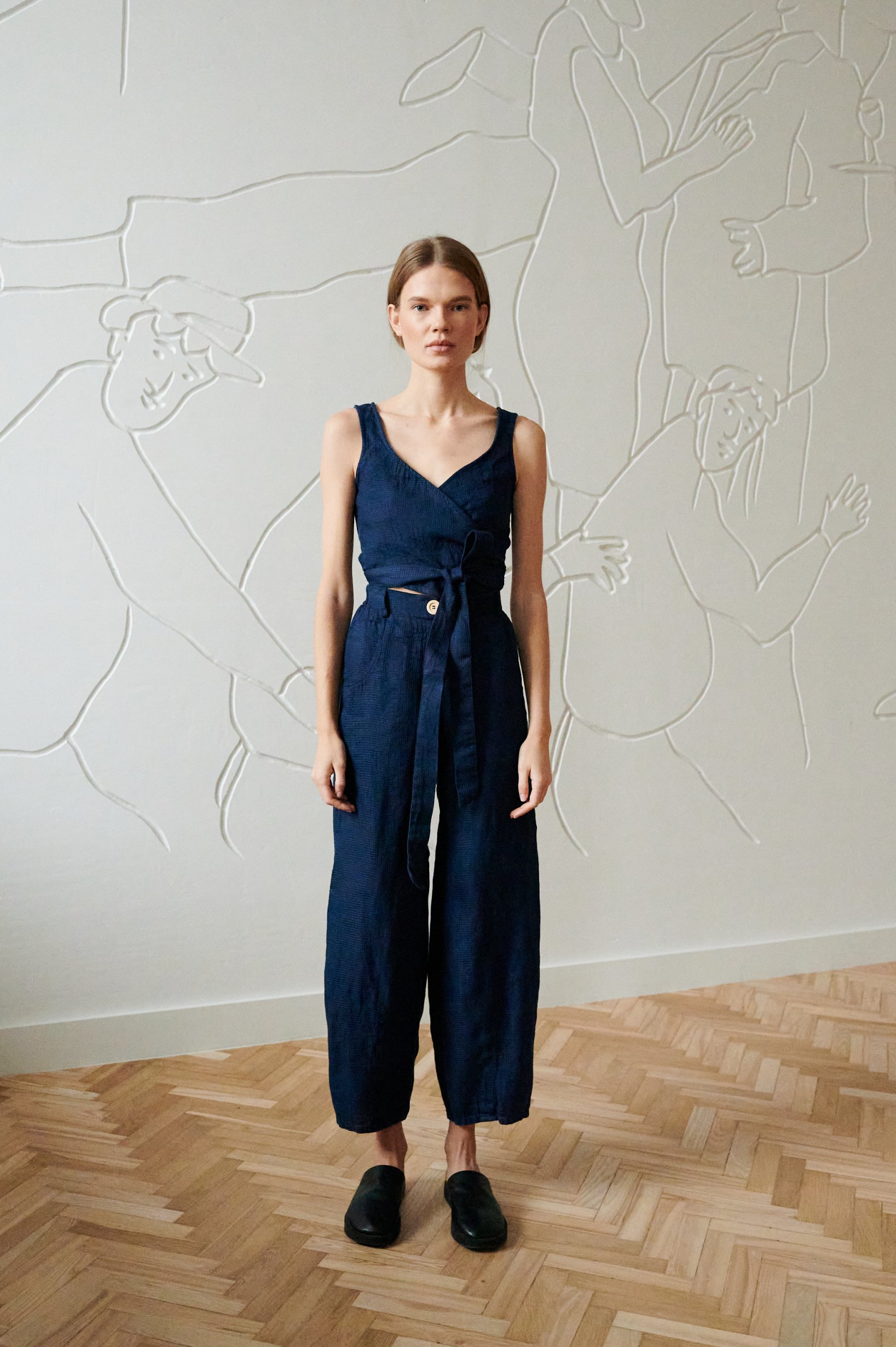 tapered linen trousers and a wrap top in dark navy