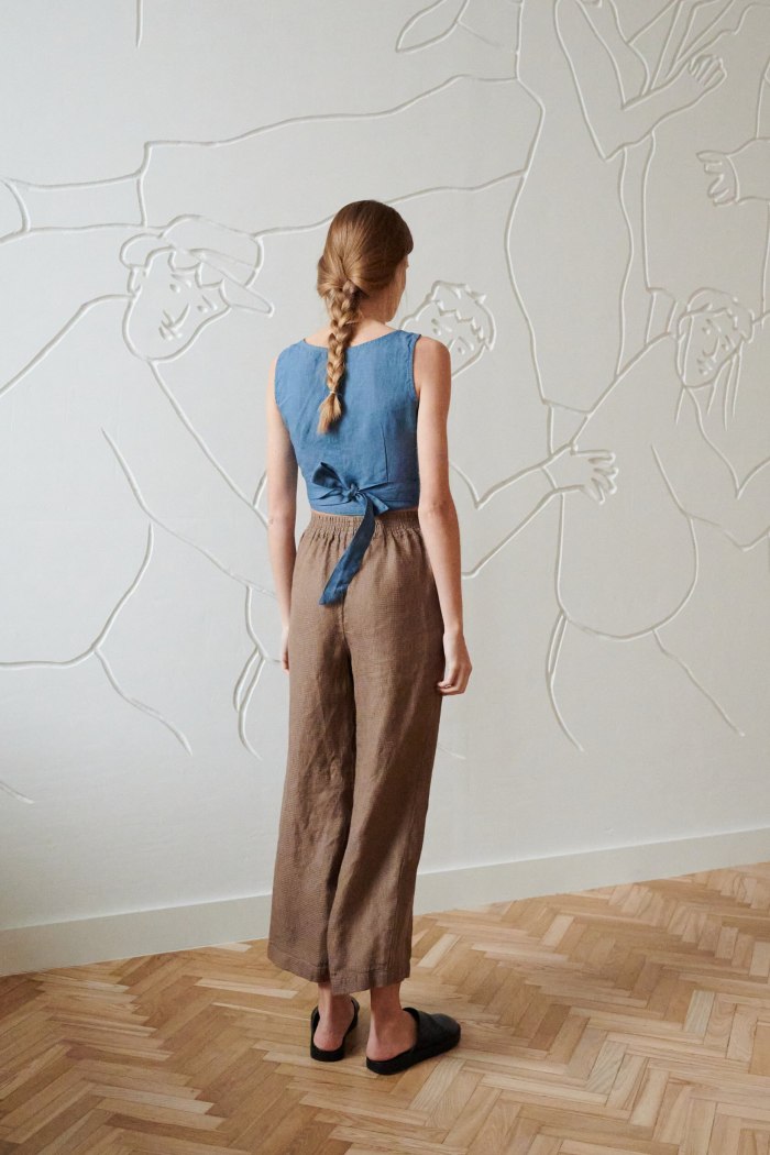 the back of wide loose fitting brown linen trousers