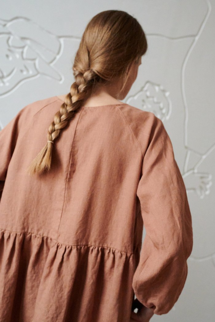the back of oversized long raglan sleeve dress in light brown