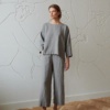 Linenfox model in grey loose-fitting trousers and a matching oversized linen top with three-quarter sleeves