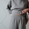 Elasticated waist of high waisted grey linen trousers
