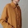 Woman wearing a loose-fitting linen utility jacket with wooden buttons