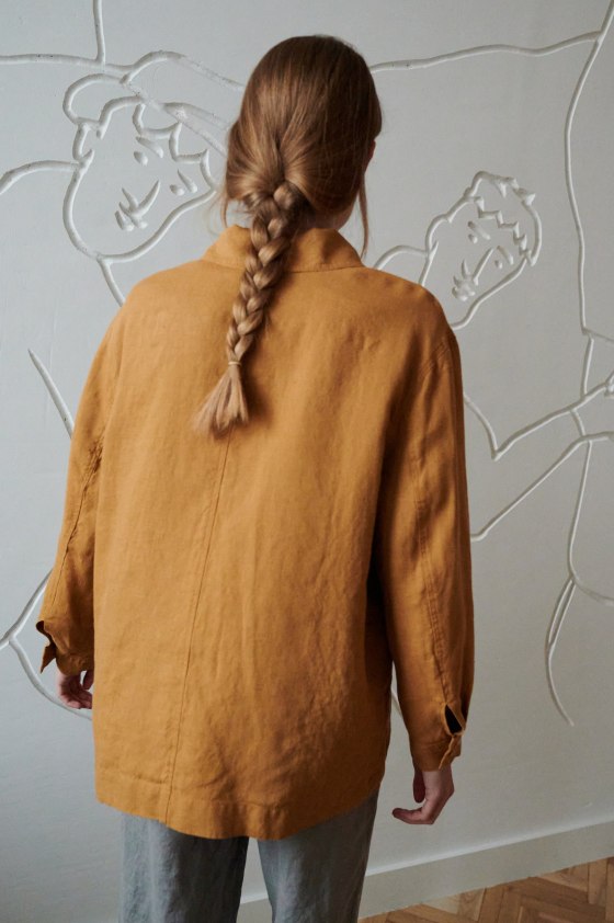 Back of a model wearing a relaxed fit linen jacket