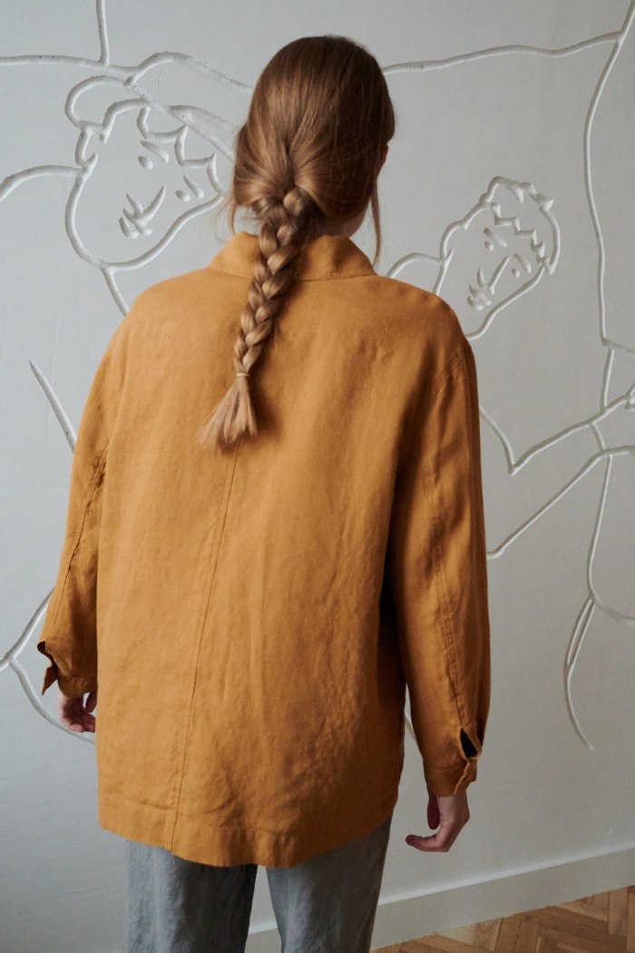 Back of a model wearing a relaxed fit linen jacket