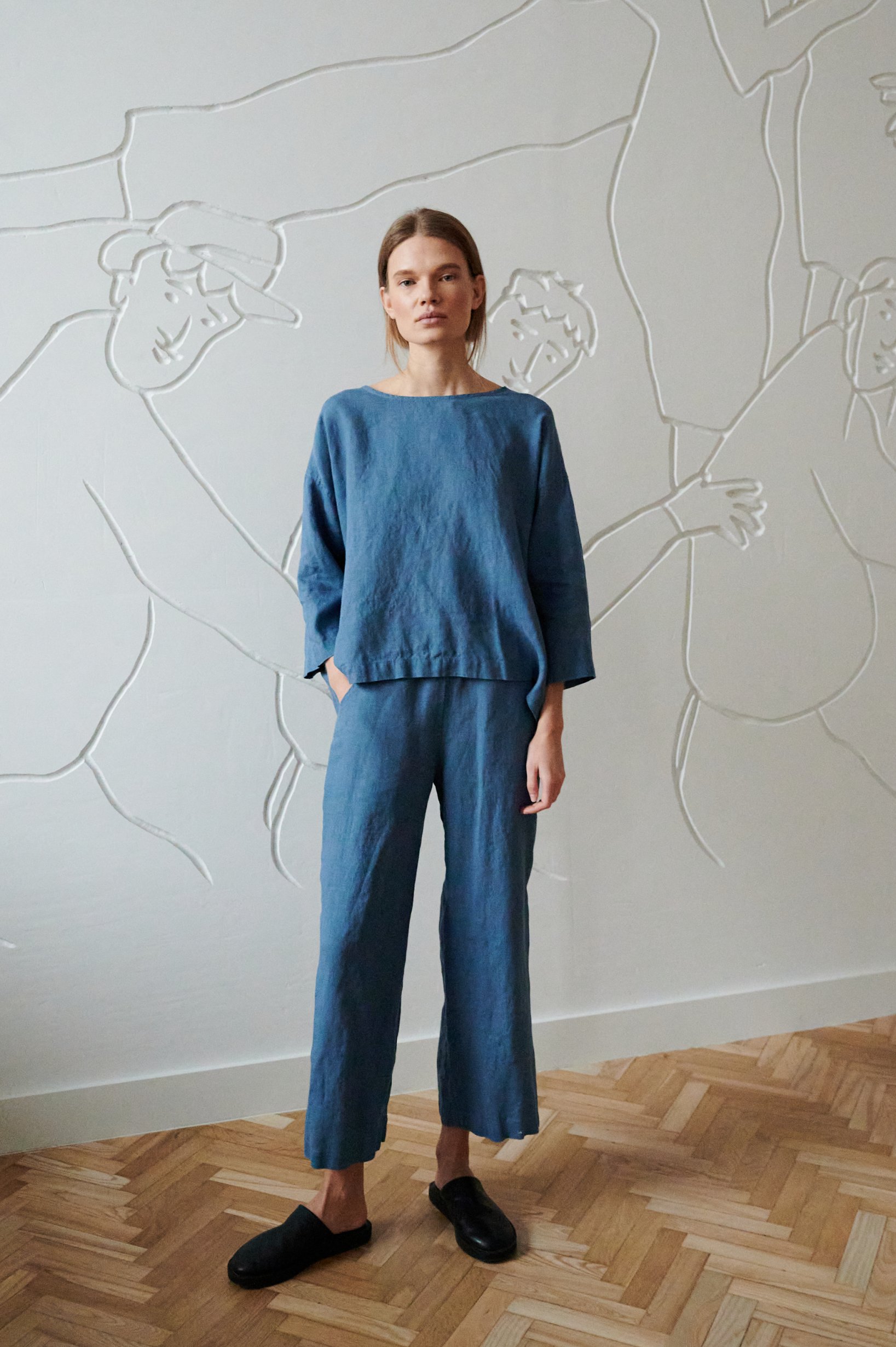 Model in a casual blue linen top and matching wide-leg linen pants outfit