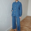 Blue wide-leg linen trousers paired with a matching linen utility jacket