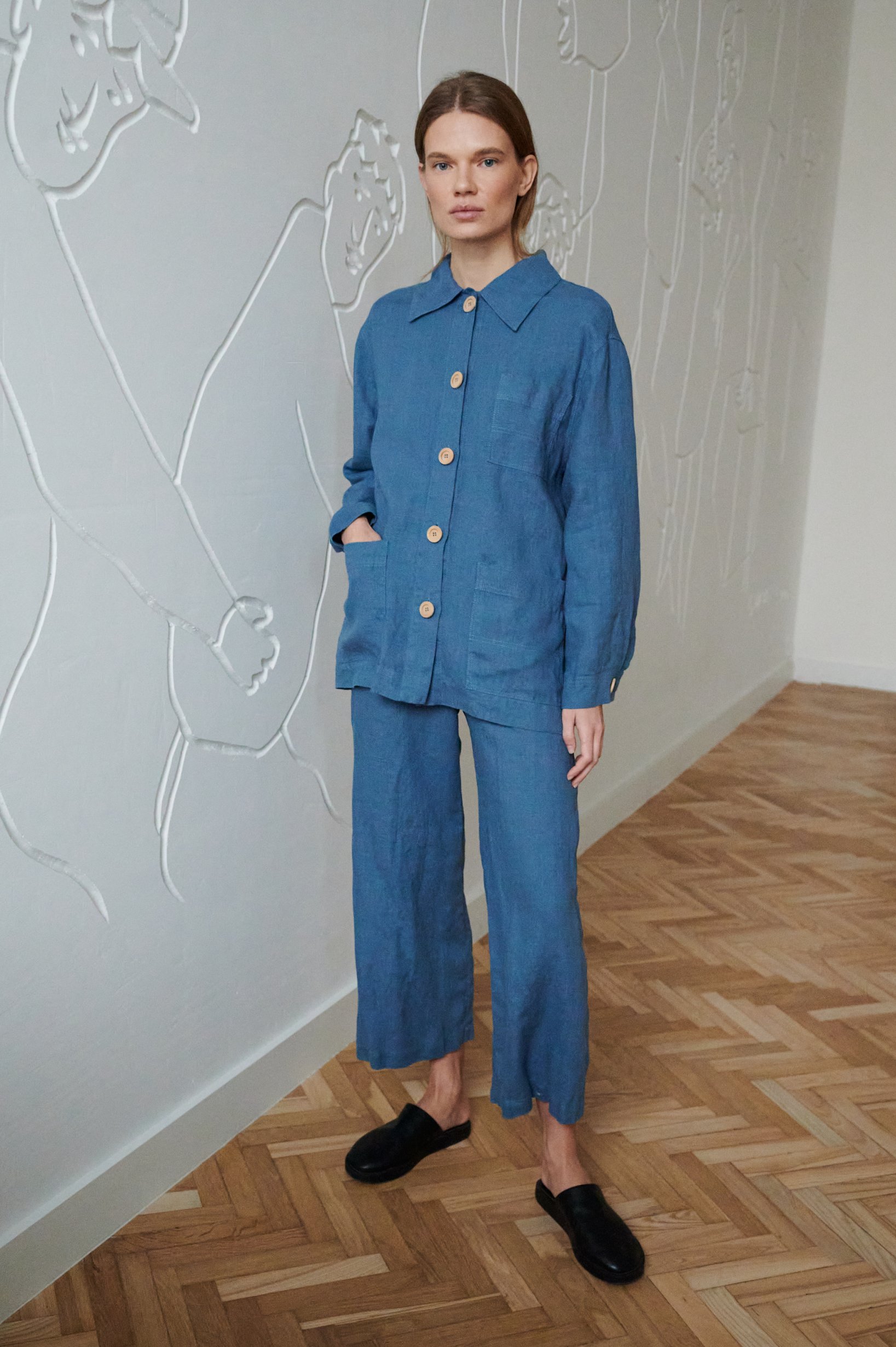 Blue wide-leg linen trousers paired with a matching linen utility jacket