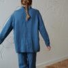 Back of an oversized blue linen jacket with buttoned sleeves