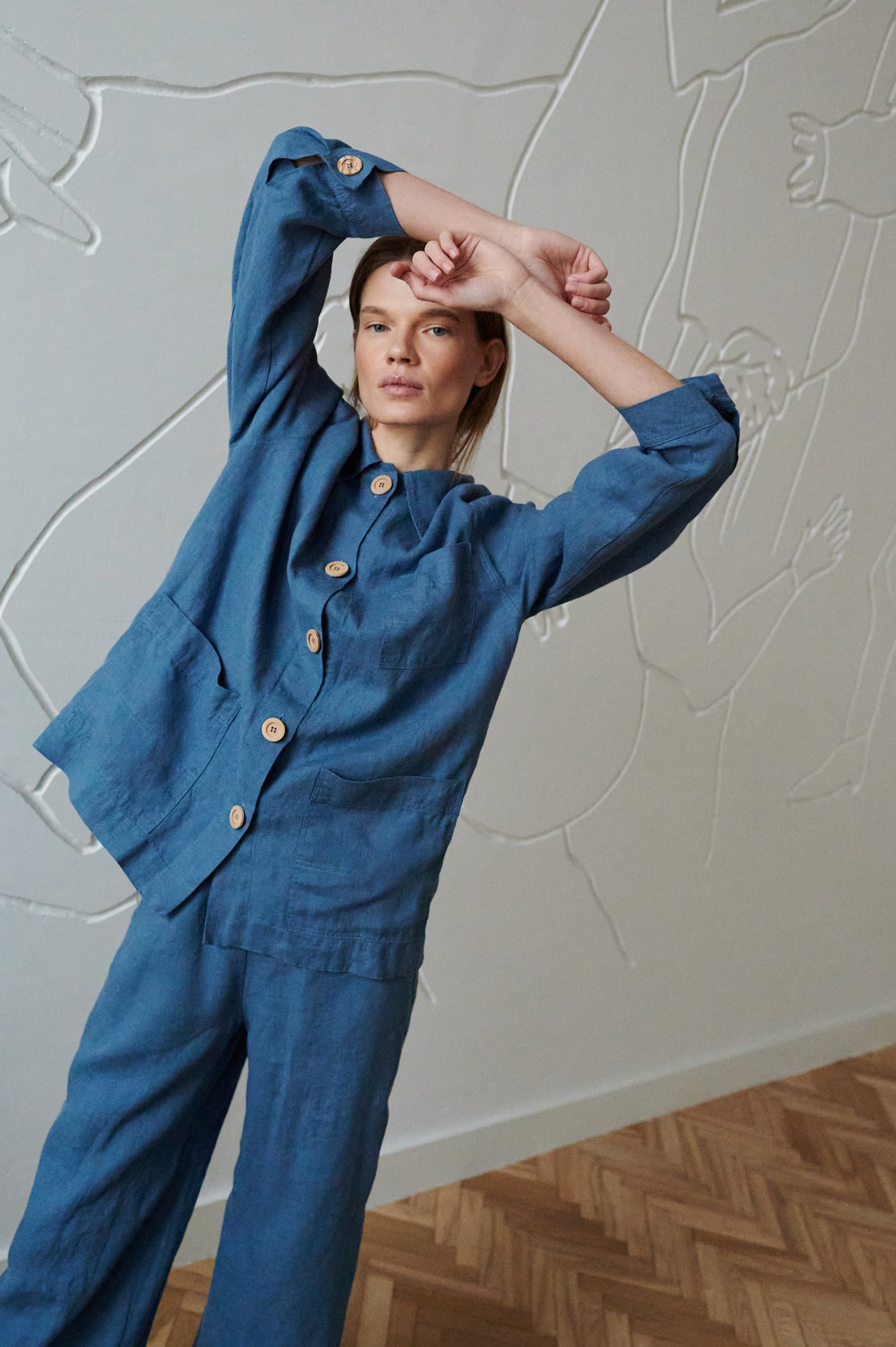 An oversized utility style blue linen jacket with wooden buttons