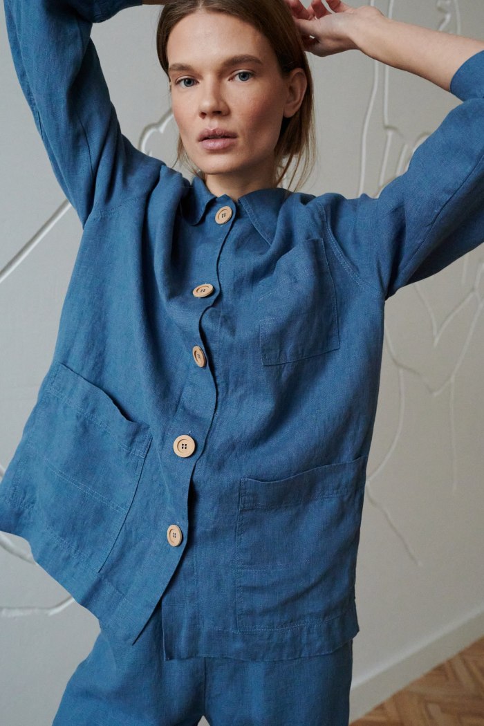 Model wearing a loose-fitting linen jacket with three patch pockets