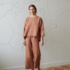 Model in wide-leg linen trousers and a matching linen tunic