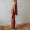 Linenfox model wearing a mocha loose-fitting linen top with matching linen trousers