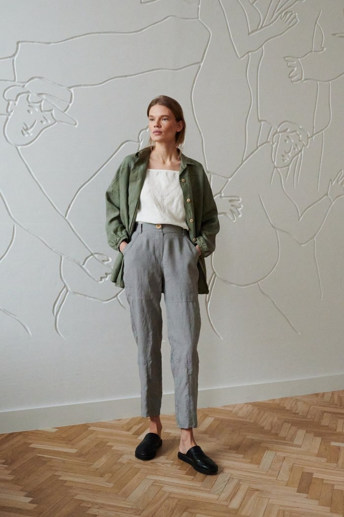 Model wearing high-waisted wide-leg linen trousers and an oversized linen shirt outfit