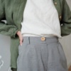 High-waisted linen trousers with a decorative wooden button
