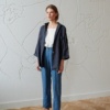 Model in a relaxed fit linen shirt and cropped loose-fitting linen trousers