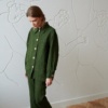 Linenfox model wearing a green loose-fitting linen utility jacket and matching linen trousers outfit