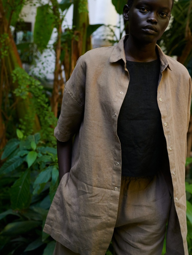 model wearing a summer linen set of short-sleeved linen shirt, and wide leg trousers in mocha mousse