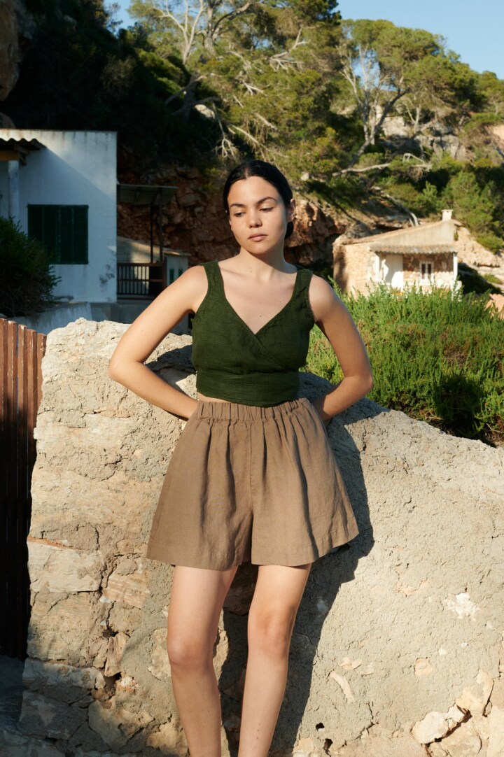 women is wearing brown linen shorts in hot weather
