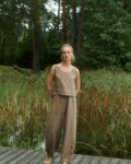 model is wearing wide leg barrel pants in brown linen
