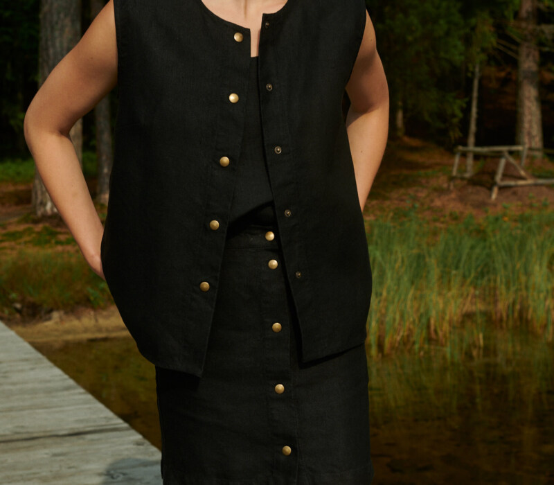 women is wearing black button up skirt made from heavy linen fabric