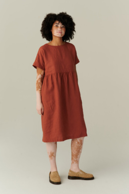 model wearing terracotta linen dress