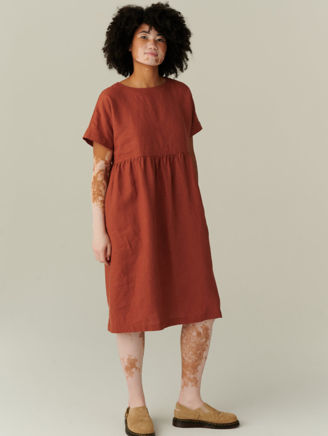 model wearing terracotta linen dress