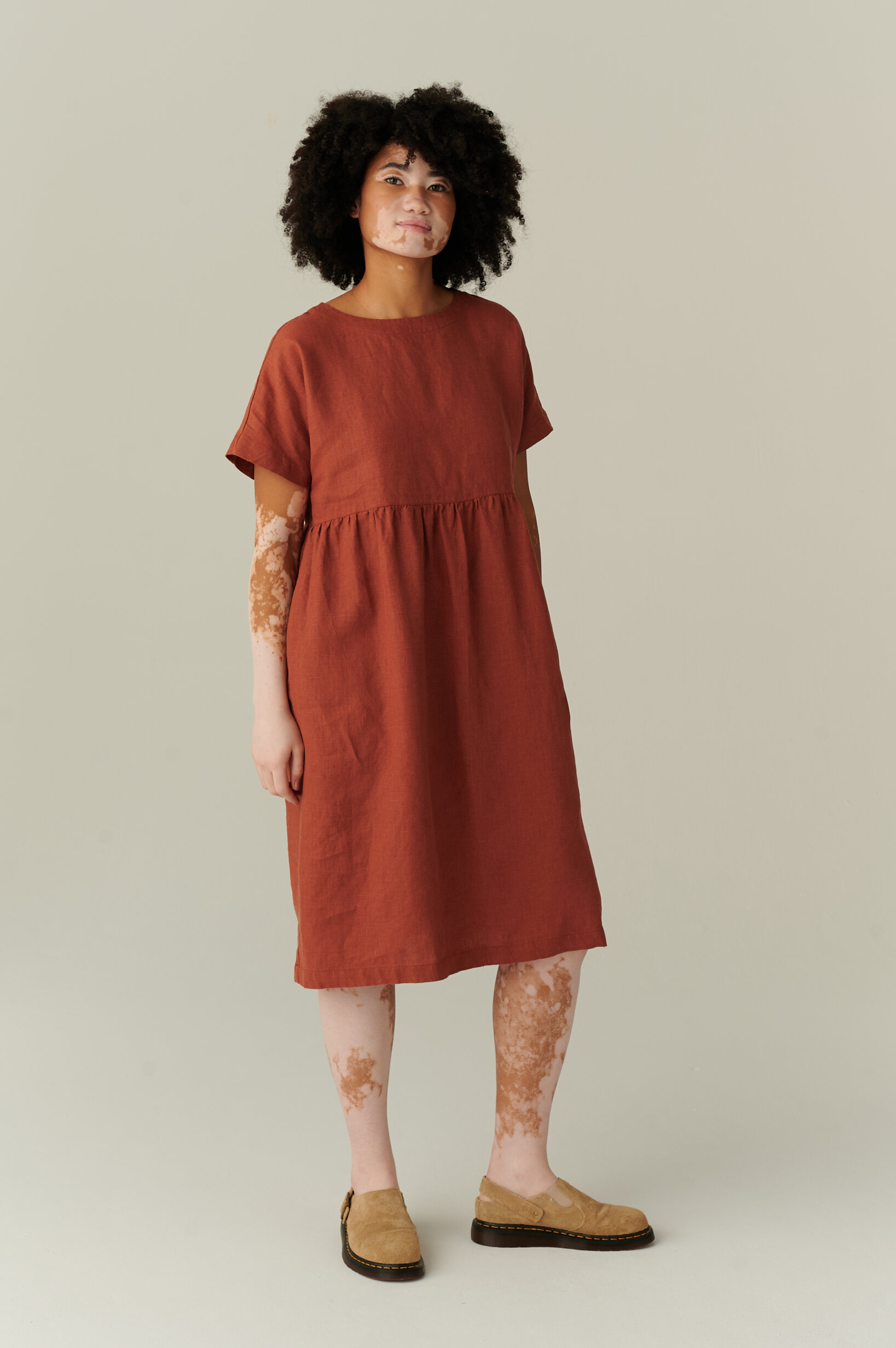 model wearing terracotta linen dress