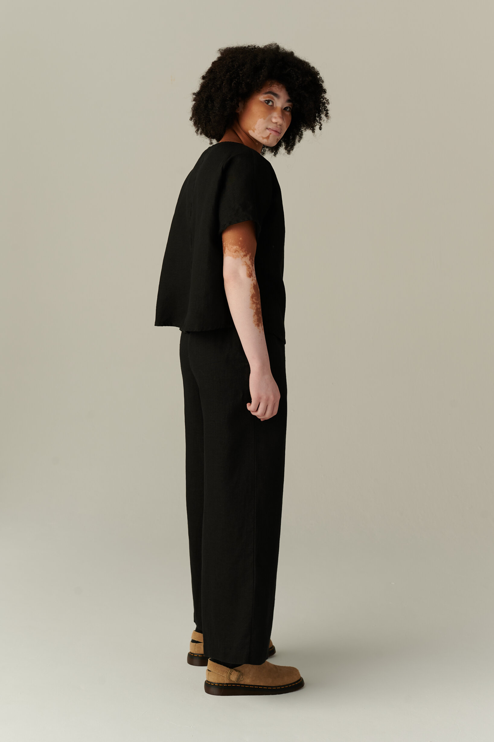 An all black linen loose fitting shirt and trousers outfit
