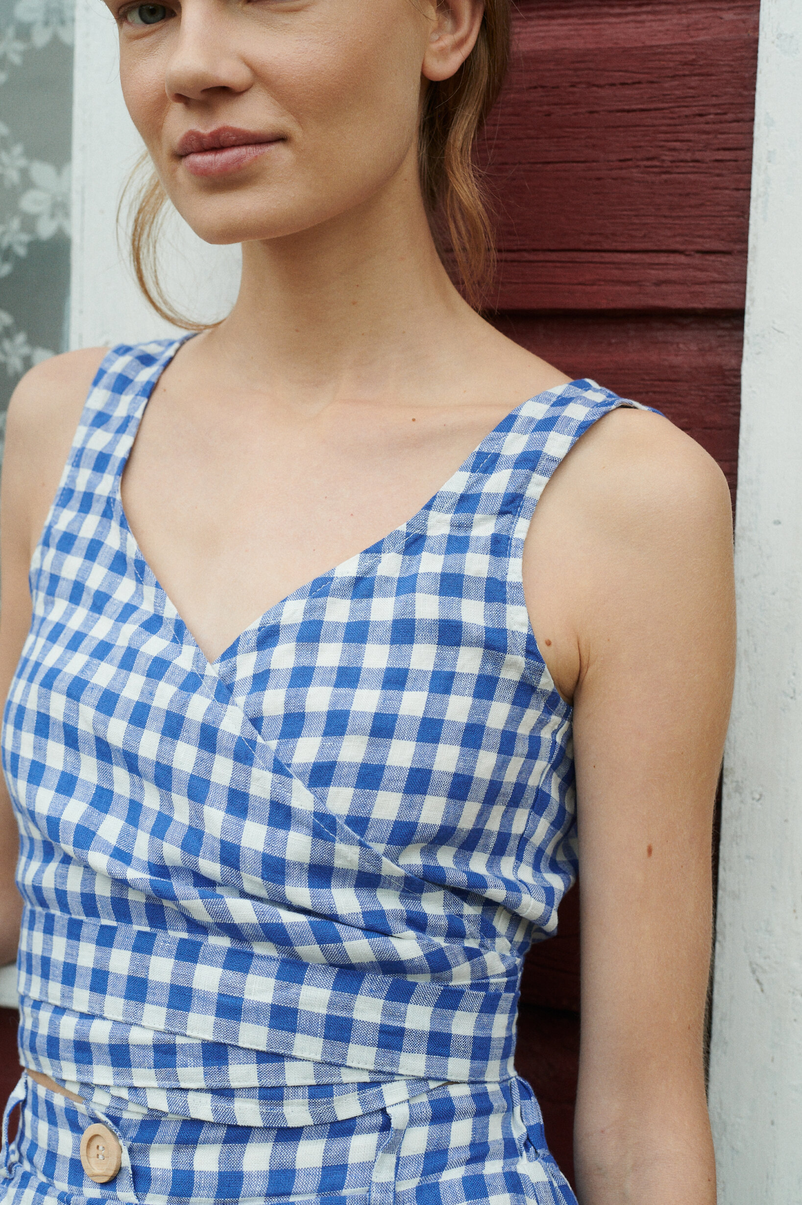 a close up shot of wrap top for summer in blue gingham linen