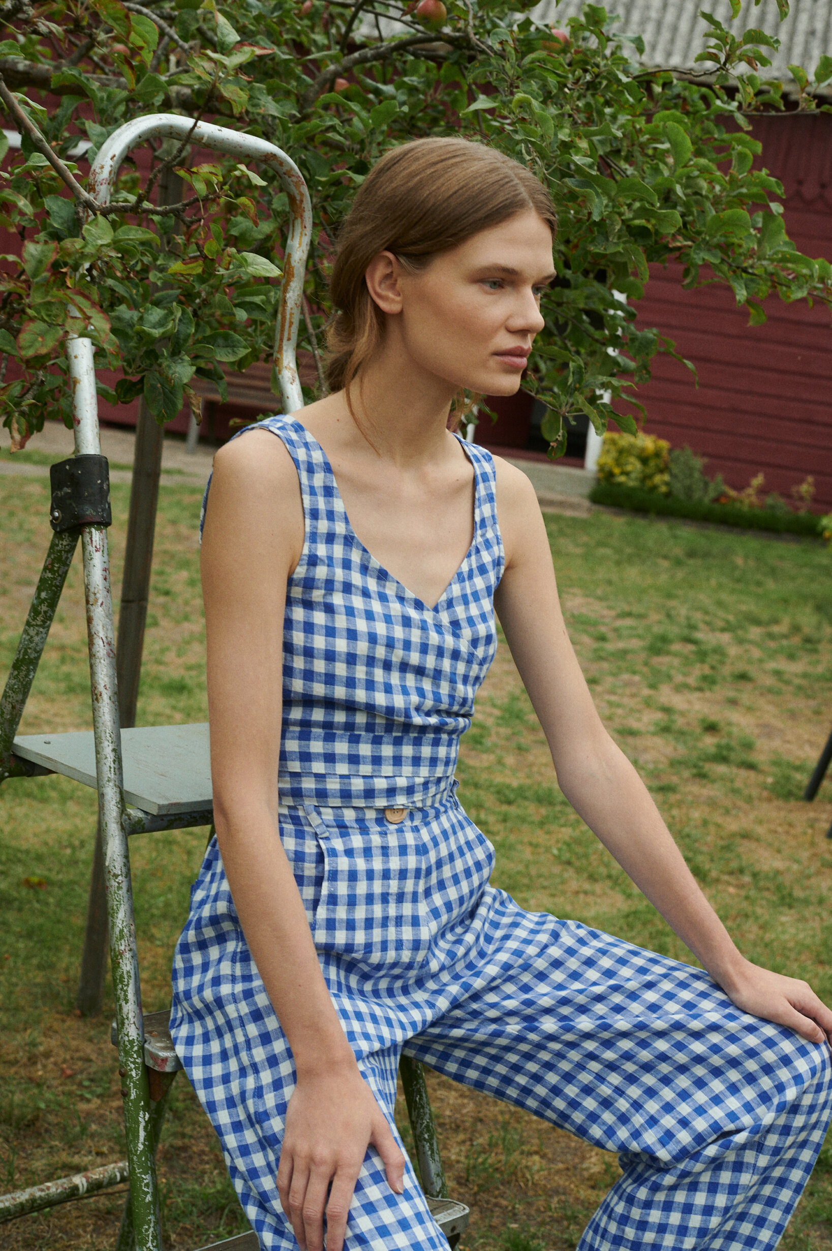 model wearing summer linen top and matching relaxed fit trousers in blue gingham linen