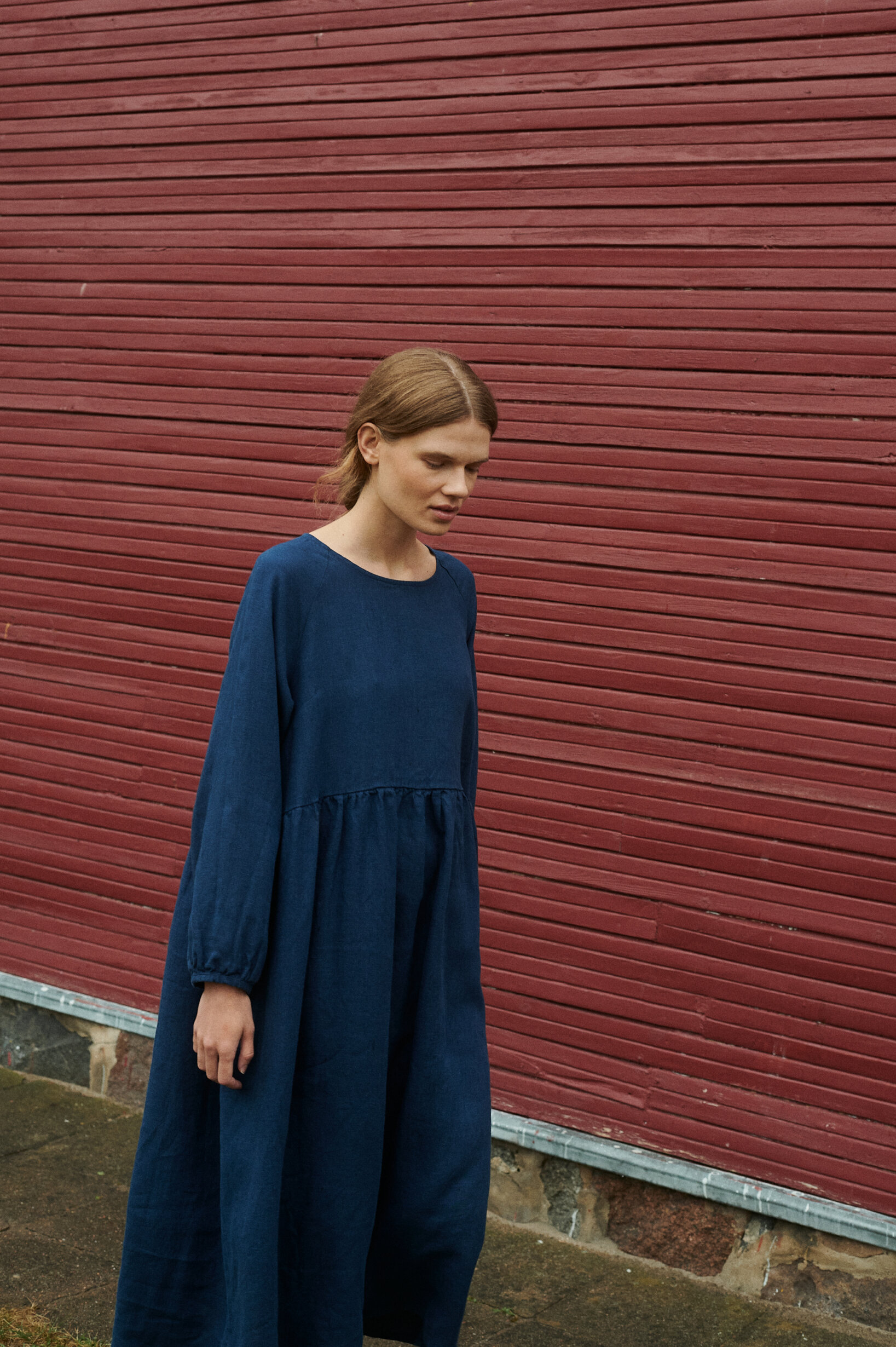 a model wearing oversized linen dress in navy blue natural linen with pockets