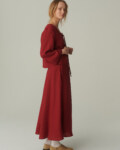 women is wearing linen maxi skirt with pockets in burgundy red color