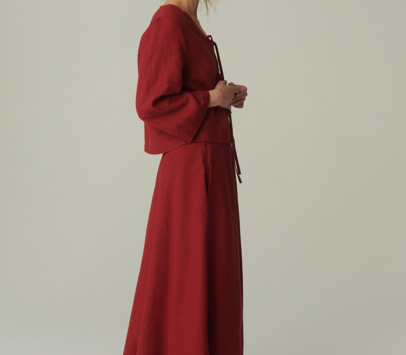 women is wearing linen maxi skirt with pockets in burgundy red color