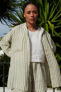 Woman in a lightweight oversized linen shirt with matching linen olive stripes shorts