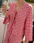 model is wearing red gingham top